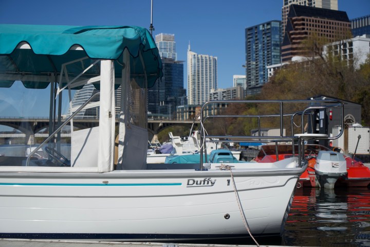 a boat is docked next to a body of water