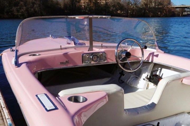 a boat sitting on top of a car