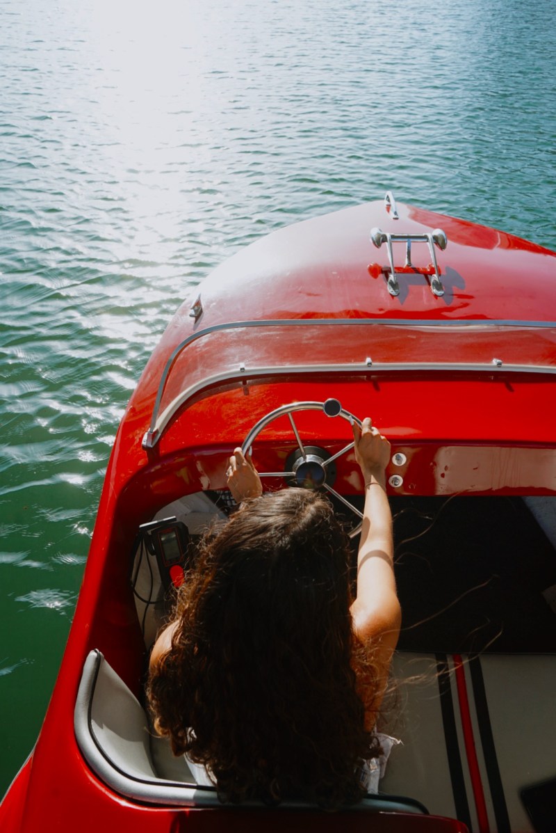 IMG_3083 a person sitting in a boat on a body of water