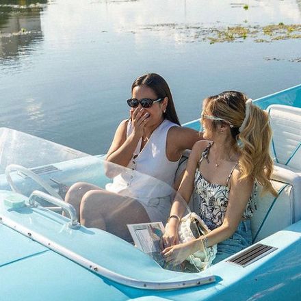 a woman sitting on a boat in the water