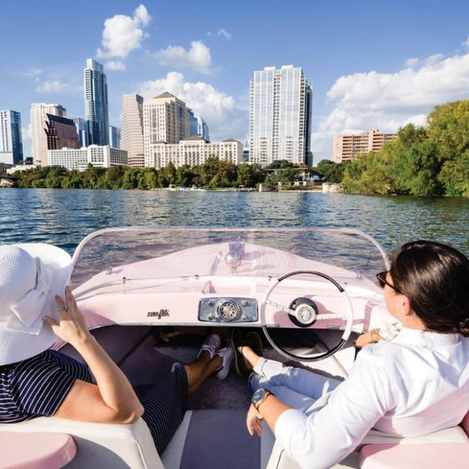 a group of people sitting in front of a body of water
